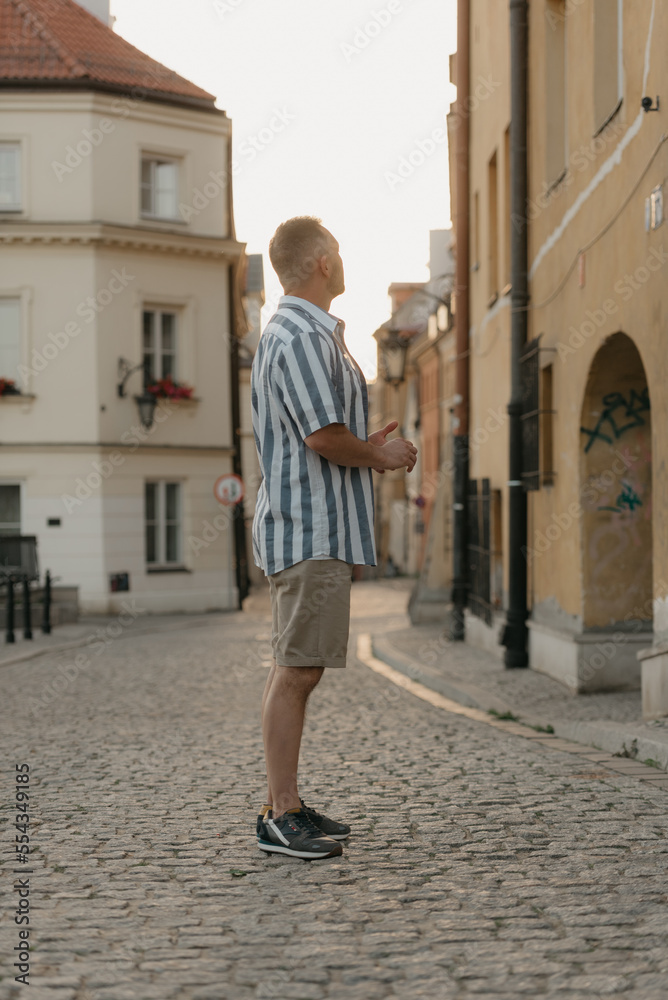 A middle-aged male tourist is looking at the sights in an old European town
