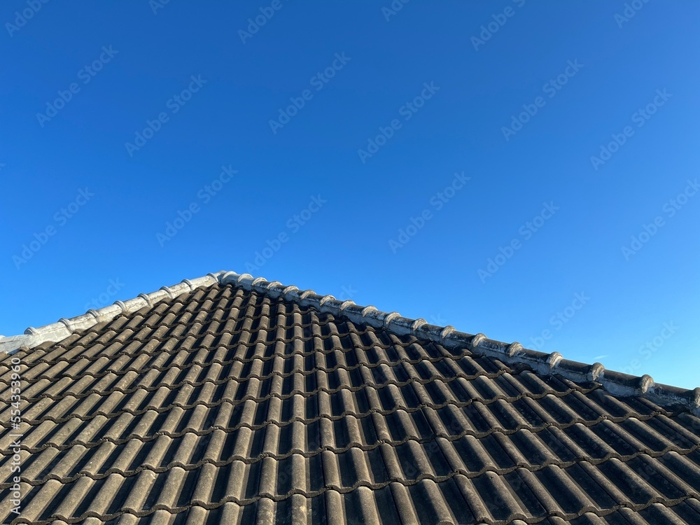 Brand new grey rooftop against blue sky in the morning. Brand new grey rooftop against blue sky in the morning.