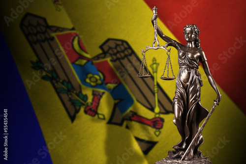 Moldova flag with statue of lady justice and judicial scales in dark room. Concept of judgement and punishment, background for jury topics