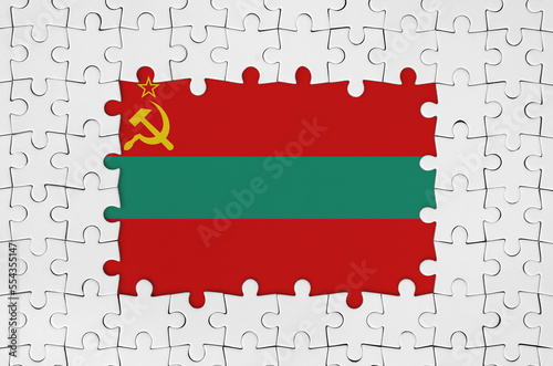 Transnistria flag in frame of white puzzle pieces with missing central parts