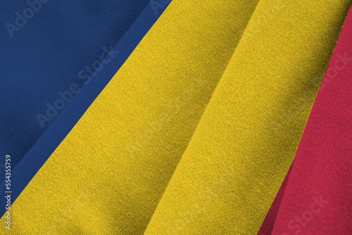 Chad flag with big folds waving close up under the studio light indoors. The official symbols and colors in fabric banner photo