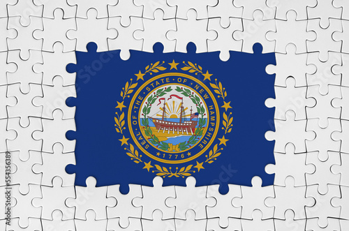New Hampshire US state flag in frame of white puzzle pieces with missing central parts photo