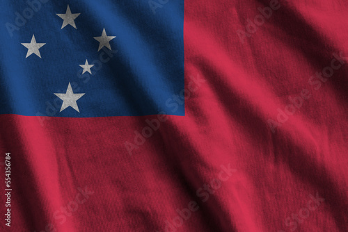 Samoa flag with big folds waving close up under the studio light indoors. The official symbols and colors in fabric banner photo
