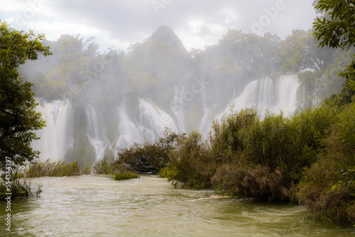 Scenery of Chongzuo Detian Waterfall in Guangxi China, dramatic sky, fog photo