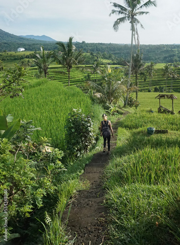 A woman walking around Tegalalang Rice field in Bali, Indonesia. photo