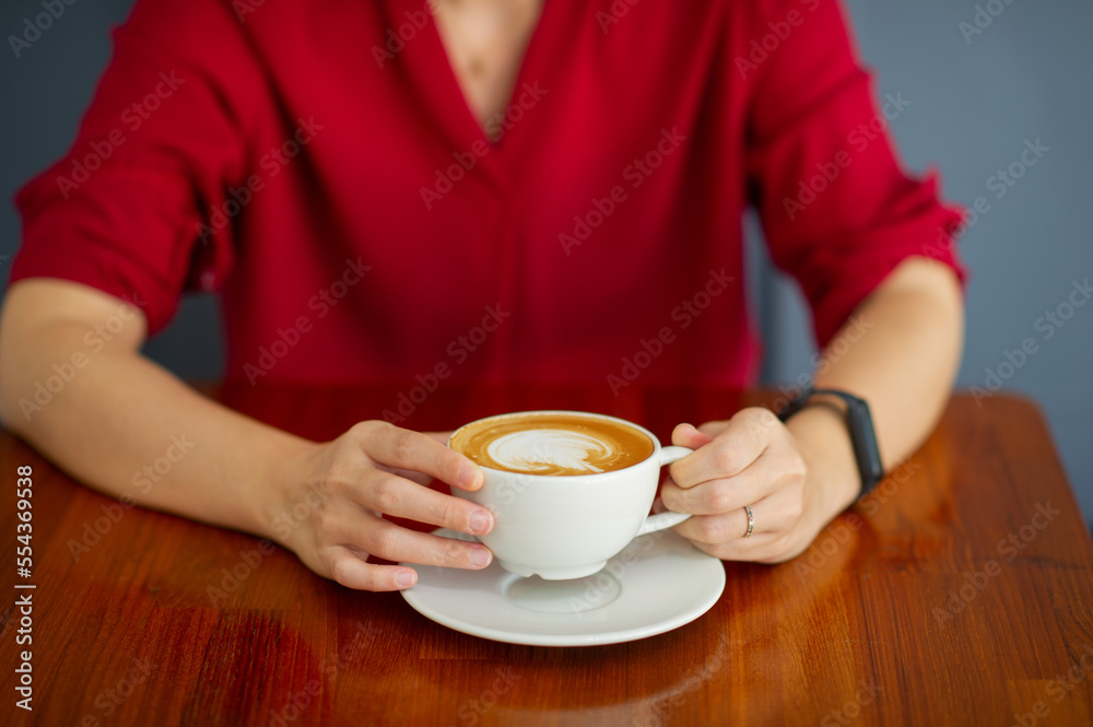 closeup hand drinking hot coffee with working, relax time closeup hand drinking hot coffee with working, relax time
