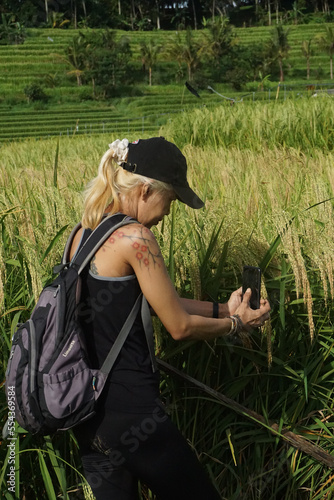 A woman walking around Tegalalang Rice field in Bali, Indonesia. photo