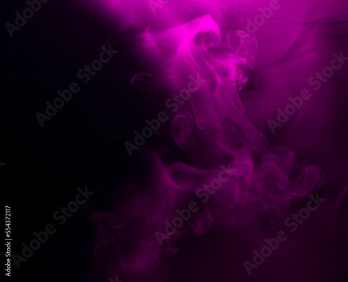 Abstract background of chaotically mixing puffs of purple smoke on a dark background