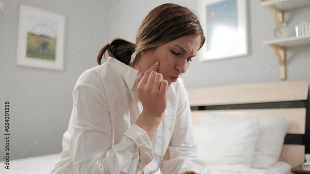 Toothache, pain in tooth. Attractive woman with caries suffers and touches her inflamed tooth and cheek with her hand Toothache, pain in tooth. Attractive woman with caries suffers and touches her inflamed tooth and cheek with her hand