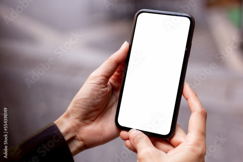 cell phone blank white screen mockup.hand holding texting using mobile on desk at office.background empty space for advertise.work people contact marketing business,technology