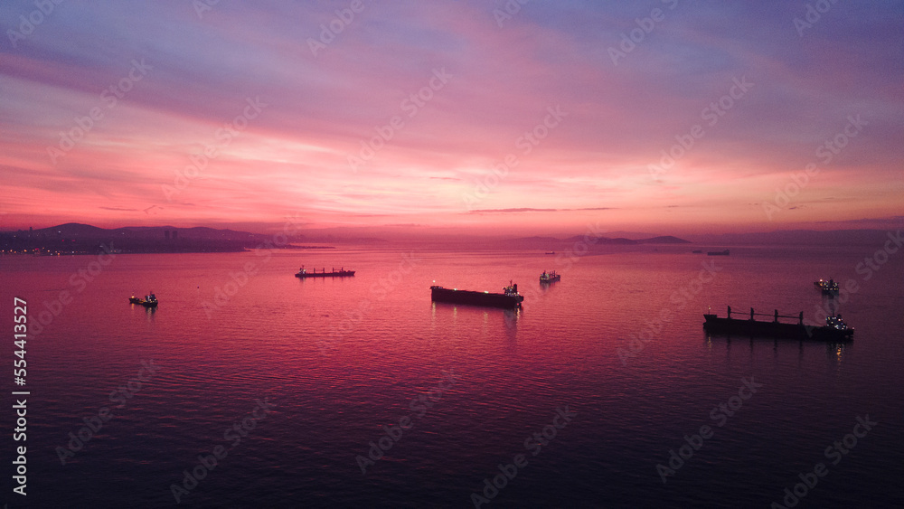 Naklejka premium aerial view of cargo ships before sunrise in sea of marmara