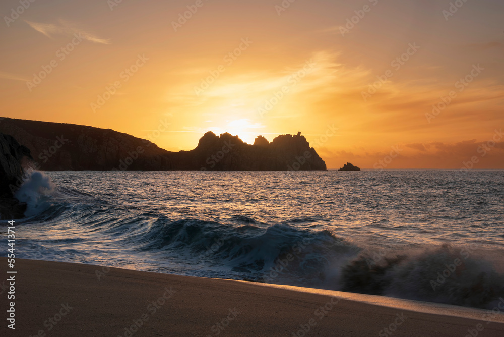 Majestic sunrise landscape at Porthcurno beach in Cornwall England with stunning colours and atmosphere