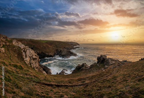 Stunning sunset landscape image of Cornwall cliff coastline with tin mines in background viewed from Pendeen Lighthouse headland © veneratio