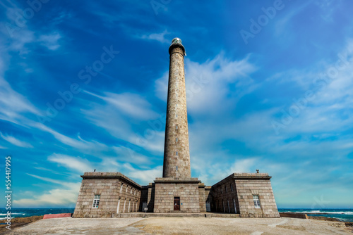 Large imposing lighthouse with a sky in cyan blue and aquamarine