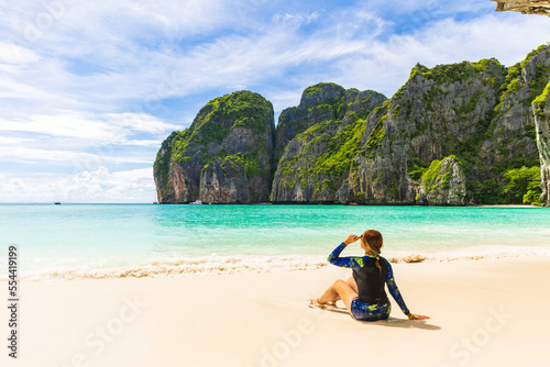 Young Asian lady tourist on the the beach, Ma Ya bay, Phi Phi island krabi province Thailand.
