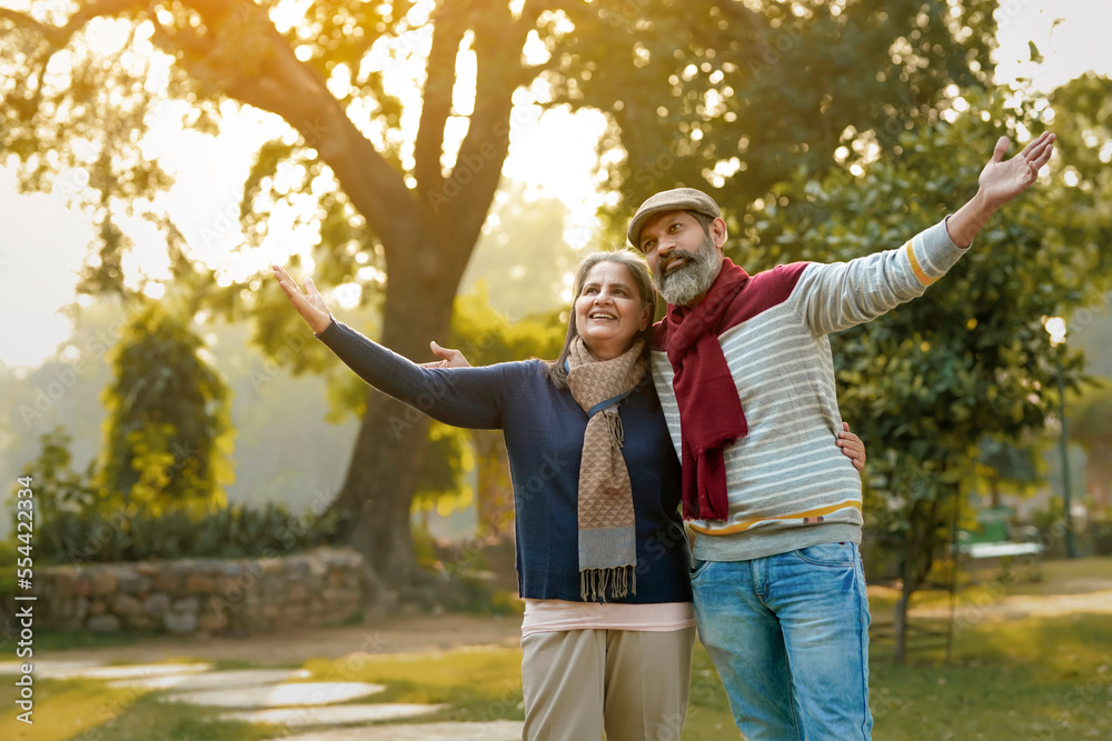 old couple in warm wear in winter at park