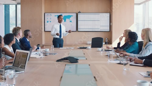 Corporate, business people and map analytics presentation in boardroom with interracial workforce. Business meeting, communication and black man presenting statistics analysis in Chicago, USA. photo