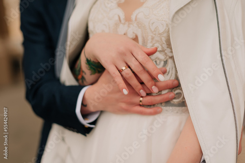 hands of bride and groom with rings