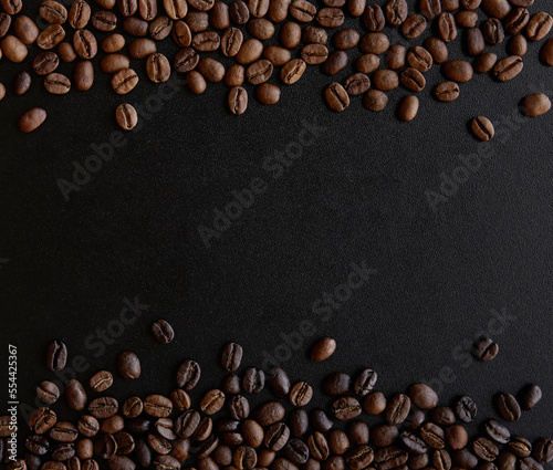 Roasted coffee beans border isolated on black background with copy space