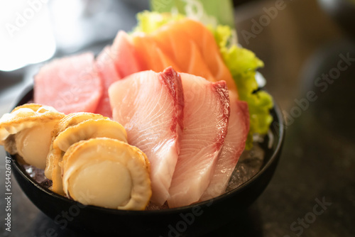 Japanese sashimi sushi set serve on ice with warm light at japanese restaurant.