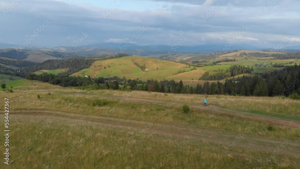Child walks alone at sunset in the Carpathian mountains in western Ukraine. Far drone shot Child walks alone at sunset in the Carpathian mountains in western Ukraine. Far drone shot
