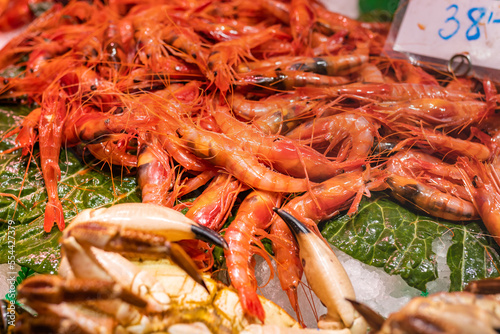 Fresh red shrimp (Aristeus antennatus) in a market in Huelva (Spain), selective focus on the center of the image. photo