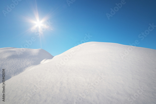 Snow hills and deep blue sunny sky. © GIS
