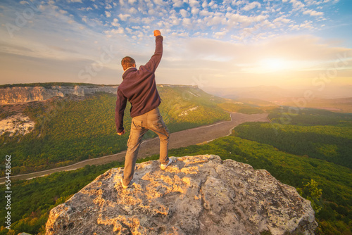 Man standing on top of mountain.