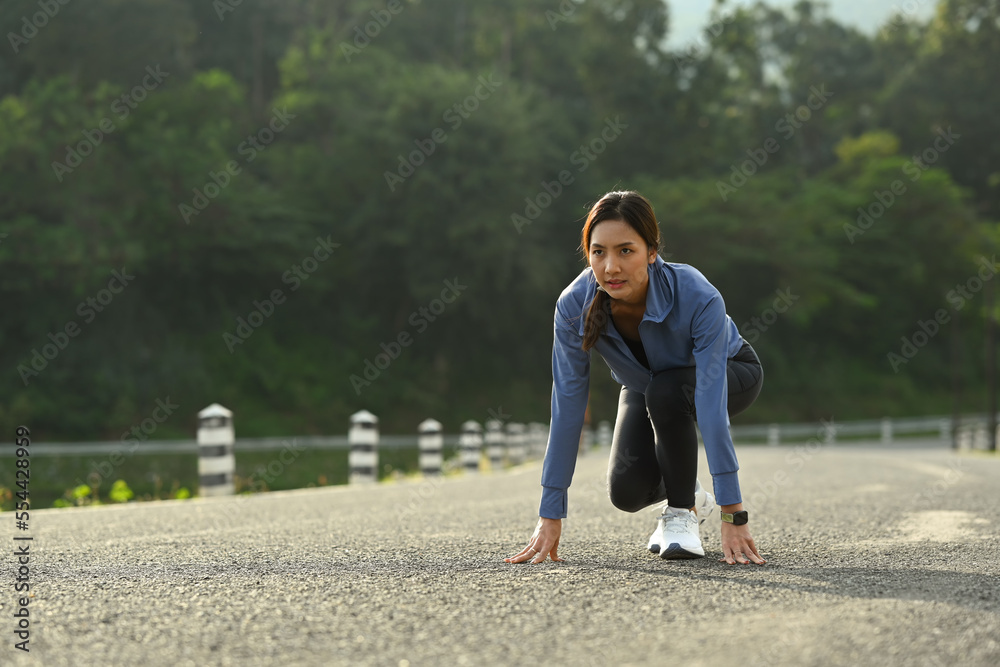 Image of athletic woman in starting position, make effort for victory, fitness, sport and healthy lifestyle concept