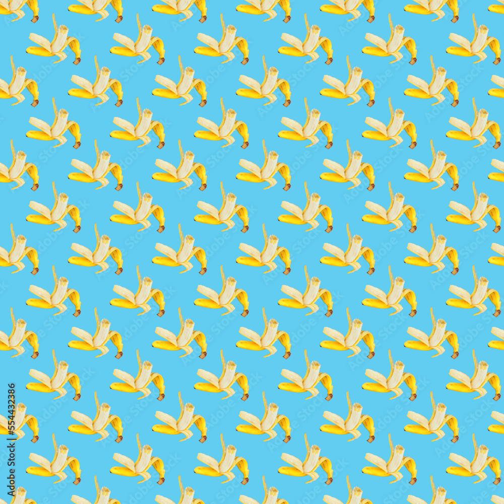 Colorful fruit pattern of fresh yellow bananas on blue background. Top view