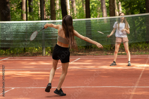 badminton outdoor, two girls play in the park in nature, sports and recreation