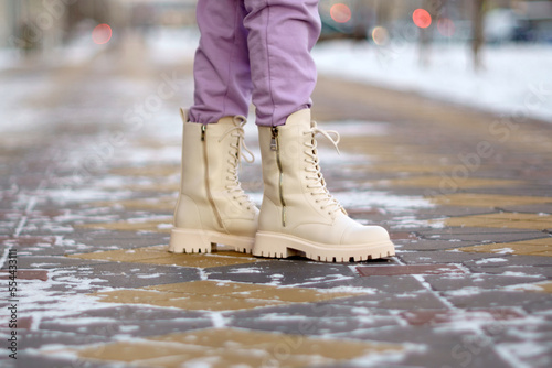 Boot close-up, walking in snow. Close up of winter shoes. Selective focus