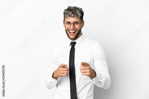 Business caucasian man isolated on white background pointing to the front and smiling