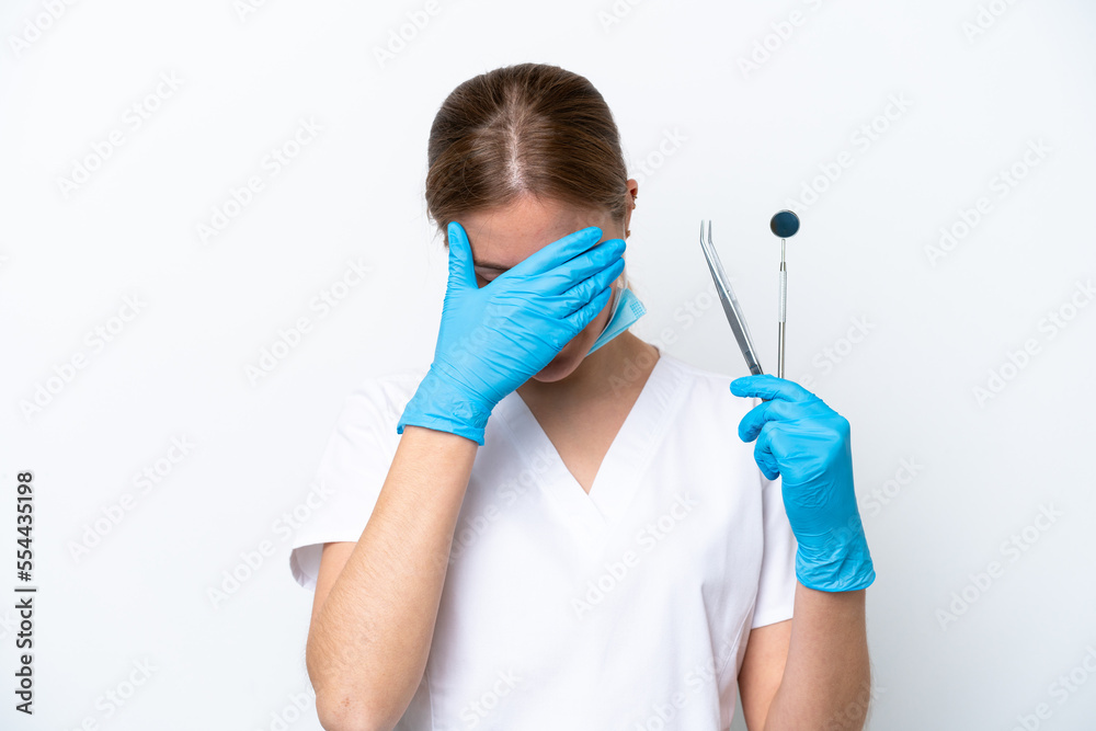 Dentist caucasian woman holding tools isolated on white background with tired and sick expression Dentist caucasian woman holding tools isolated on white background with tired and sick expression