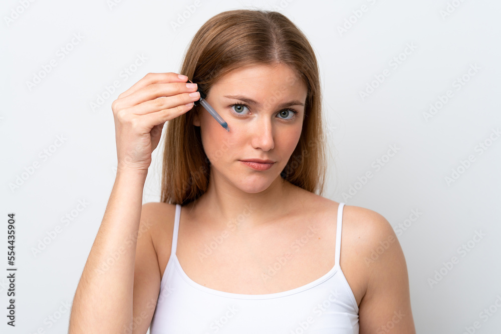 Young caucasian woman isolated on white background holding a serum. Close up portrait Young caucasian woman isolated on white background holding a serum. Close up portrait