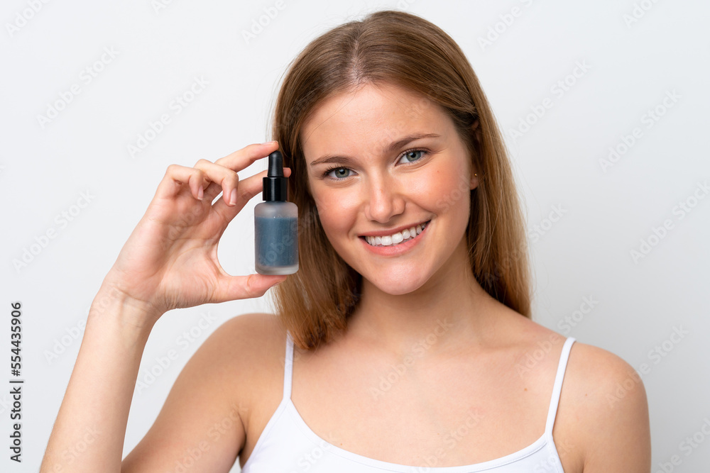 Young caucasian woman isolated on white background holding a serum while smiling. Close up portrait Young caucasian woman isolated on white background holding a serum while smiling. Close up portrait