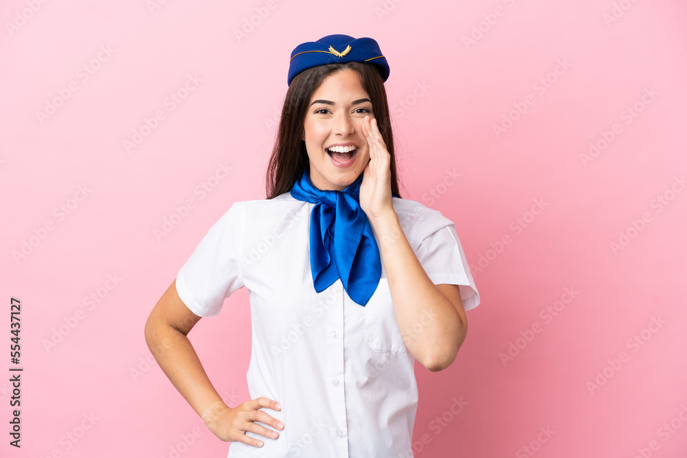 Airplane stewardess Brazilian woman isolated on pink background shouting with mouth wide open Airplane stewardess Brazilian woman isolated on pink background shouting with mouth wide open