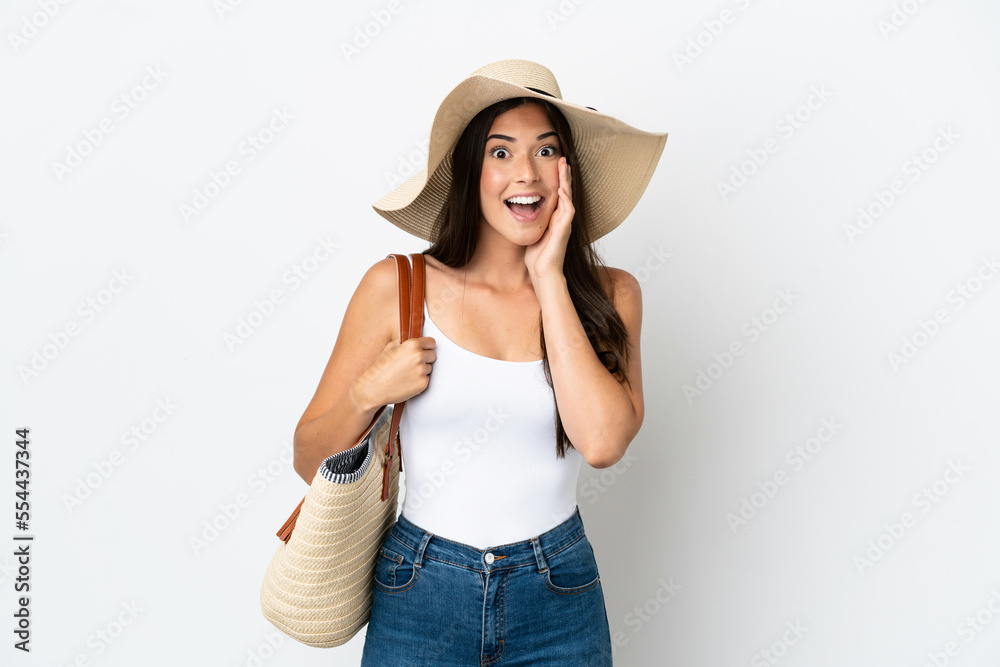 Young Brazilian woman with Pamela holding a beach bag isolated on white background with surprise and shocked facial expression Young Brazilian woman with Pamela holding a beach bag isolated on white background with surprise and shocked facial expression