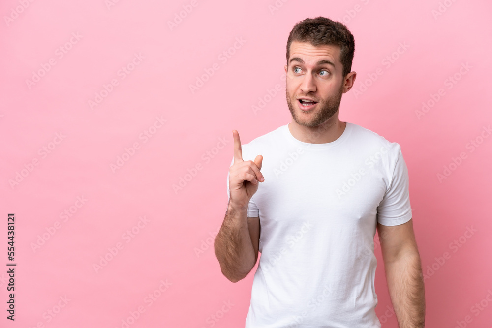 Young caucasian man isolated on pink background thinking an idea pointing the finger up Young caucasian man isolated on pink background thinking an idea pointing the finger up