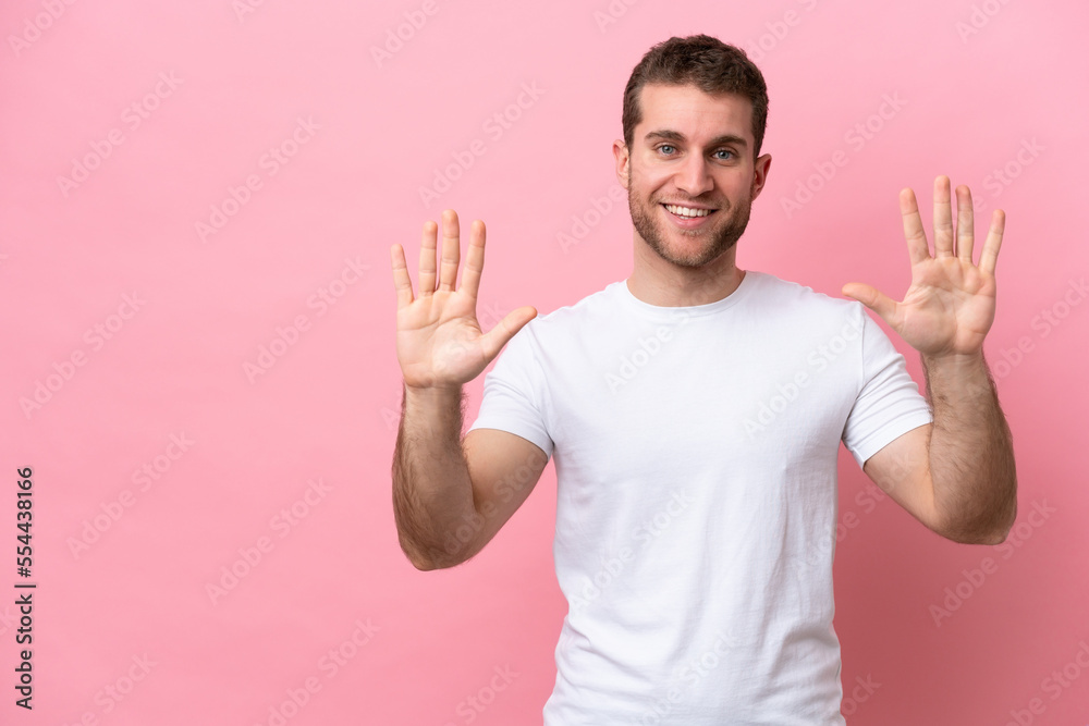 Young caucasian man isolated on pink background counting ten with fingers Young caucasian man isolated on pink background counting ten with fingers