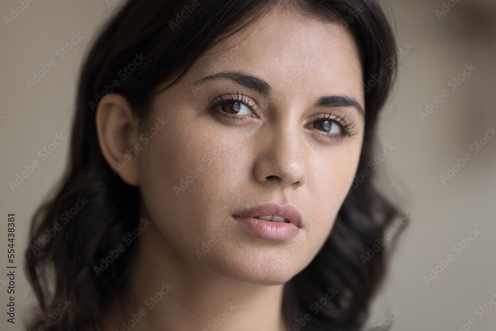 Serious beautiful young Asian woman looking at camera with thoughtful face, promoting smooth clean skin, long black eyelashes. Beauty care model close up facial portrait Serious beautiful young Asian woman looking at camera with thoughtful face, promoting smooth clean skin, long black eyelashes. Beauty care model close up facial portrait