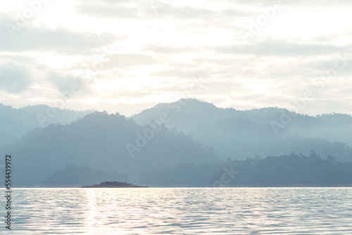 Morning sunshine relect on the river with mountain behind