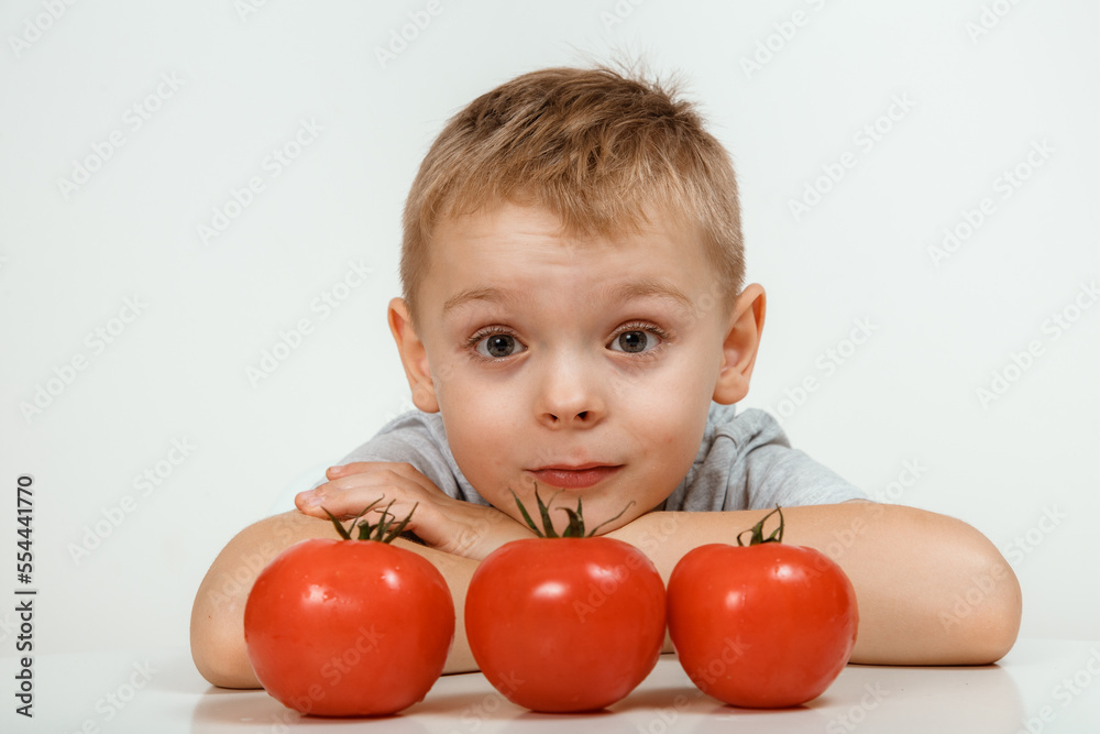 Teaching child to healthy and varied vegitarian food. Smiling cute child with vegetables in hands. Teaching child to healthy and varied vegitarian food. Smiling cute child with vegetables in hands.