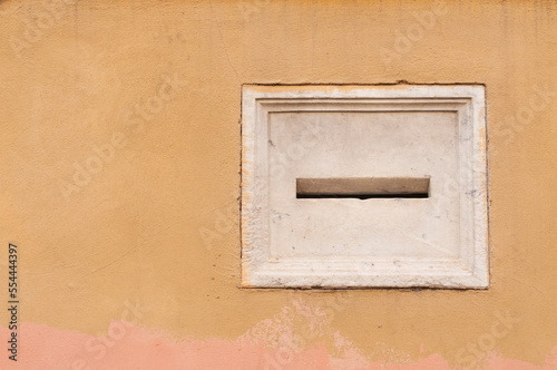 Blank marble letterbox on the facade of a historic Italian building © cristianstorto