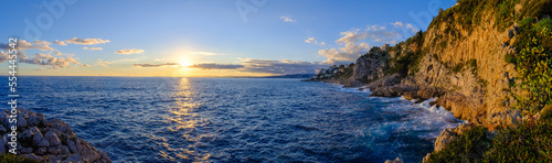 Beautiful sunset over the sea near the mountains in Nice, France. Calm seascape, panorama. © Pykodelbi