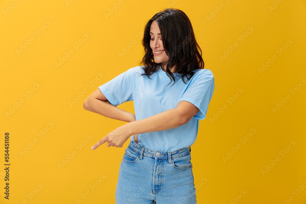 Woman signal smile with teeth emotion portrait in blue t-shirt on yellow background, hands up, surprise, lifestyle, copy space Woman signal smile with teeth emotion portrait in blue t-shirt on yellow background, hands up, surprise, lifestyle, copy space