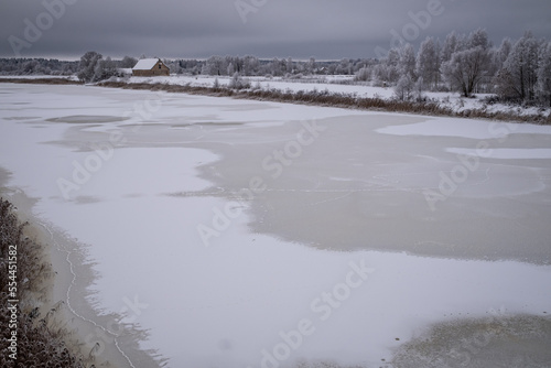 frozen snow and ice covered river Lielupe near Jelgava town in Latvia. Beautiful winter morning