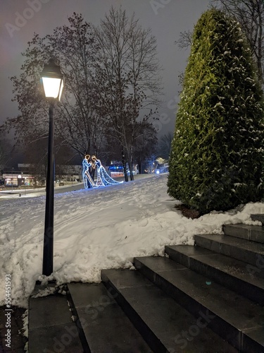 installation of a man and a woman with illumination on the snow in winter