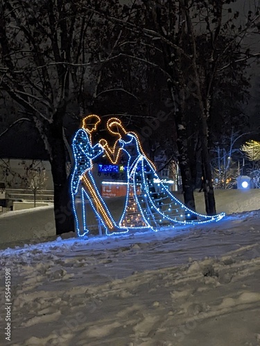 installation of a man and a woman with illumination on the snow in winter