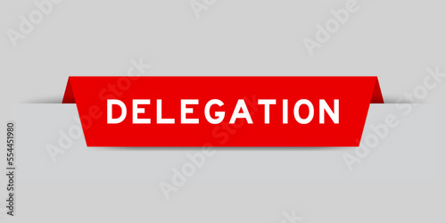 Red color inserted label with word delegation on gray background